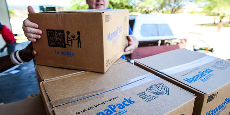 Handing out boxes of food.